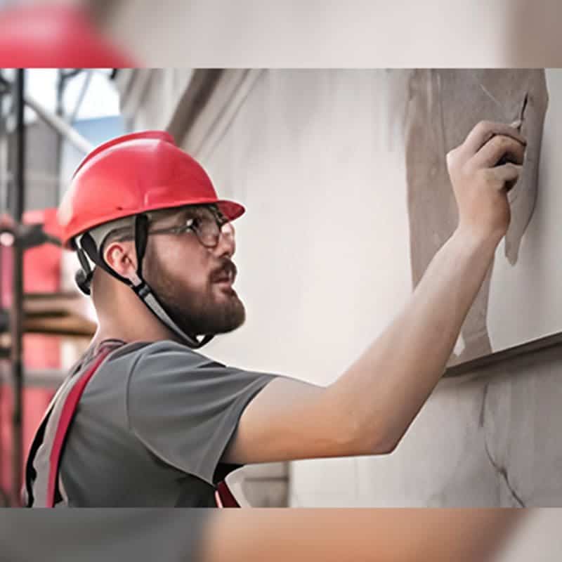 Construction worker performing finish work — DBF Consulting condo restoration services